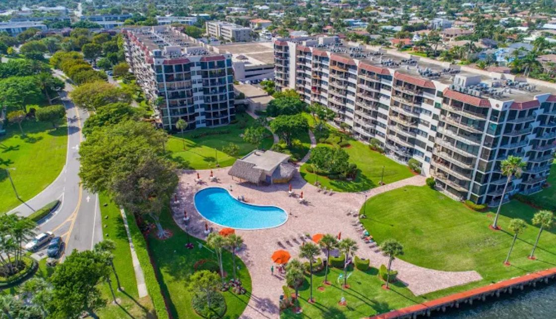 An image depicting the Porta Bella property, inclusive of the buildings, a swimming pool, and tidy grounds around the property.