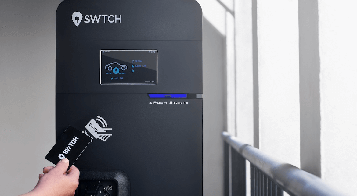 An image showing a person tapping an RFID card to an EV charger running SWTCH software